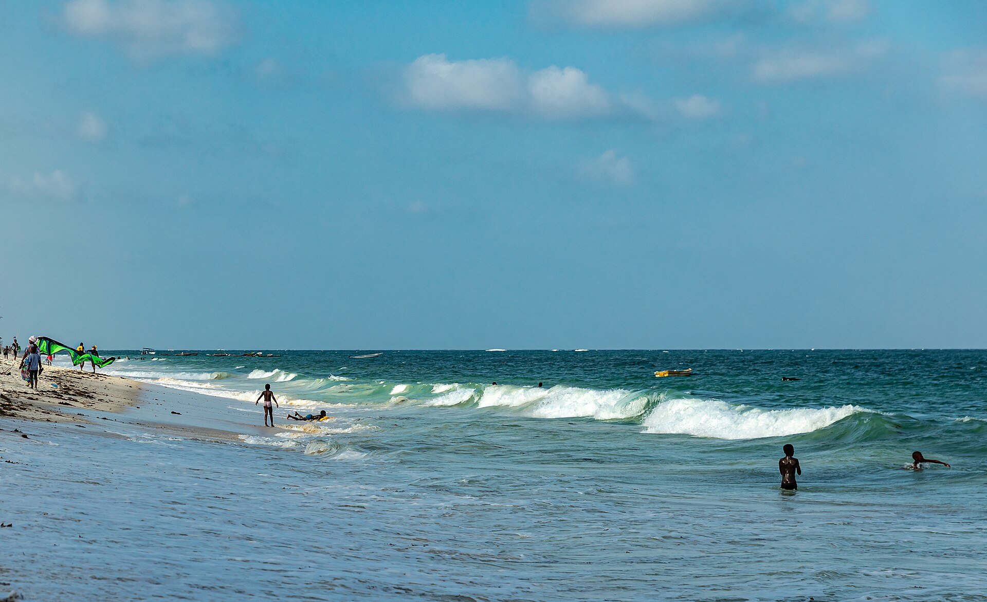 People enjoying the turquoise surf at Diani Beach